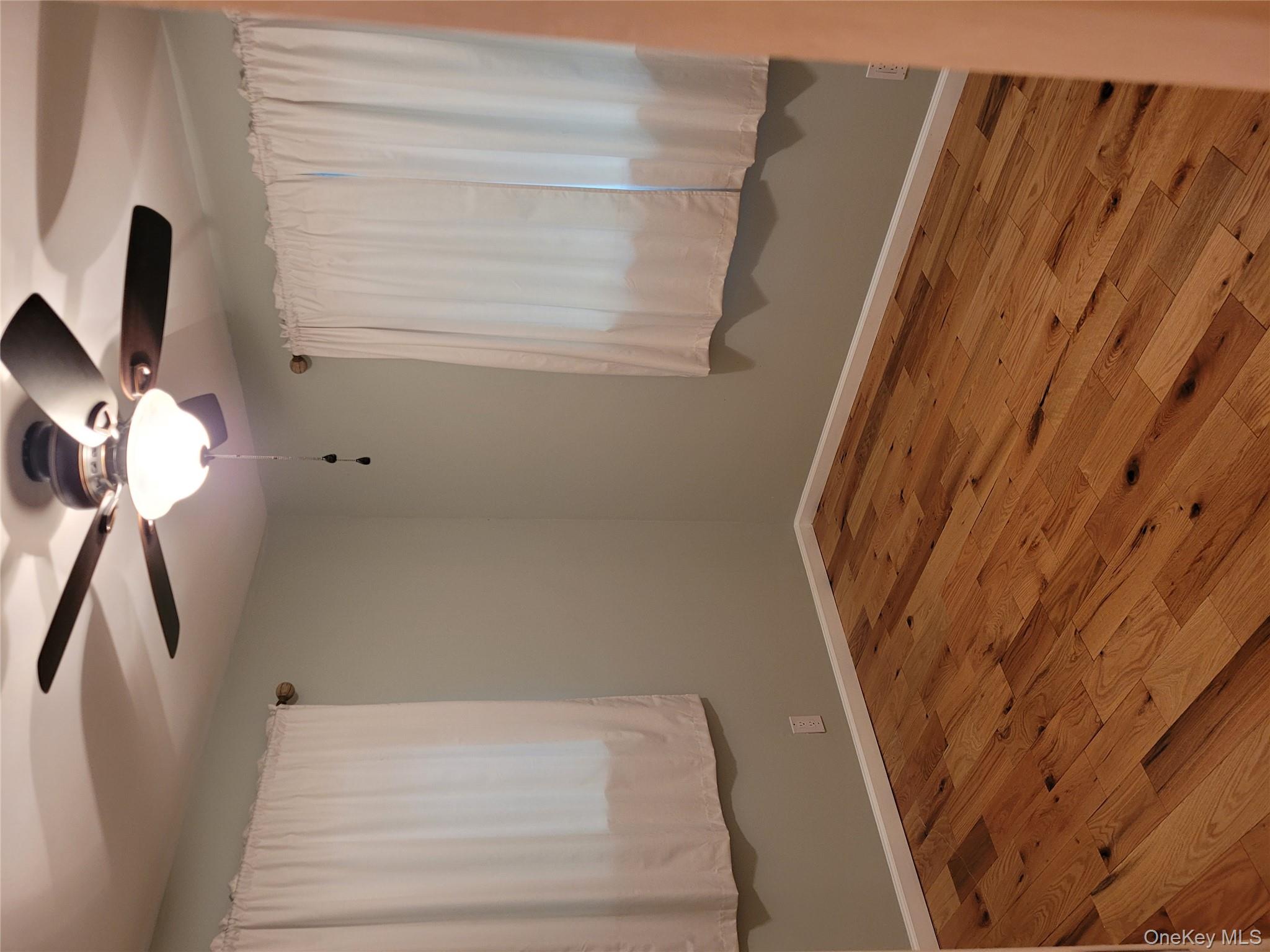 31 Apricot Road Rocky Point, NY 11778 - Photo 23 of 31 Unfurnished room with ceiling fan and wood finished floors
