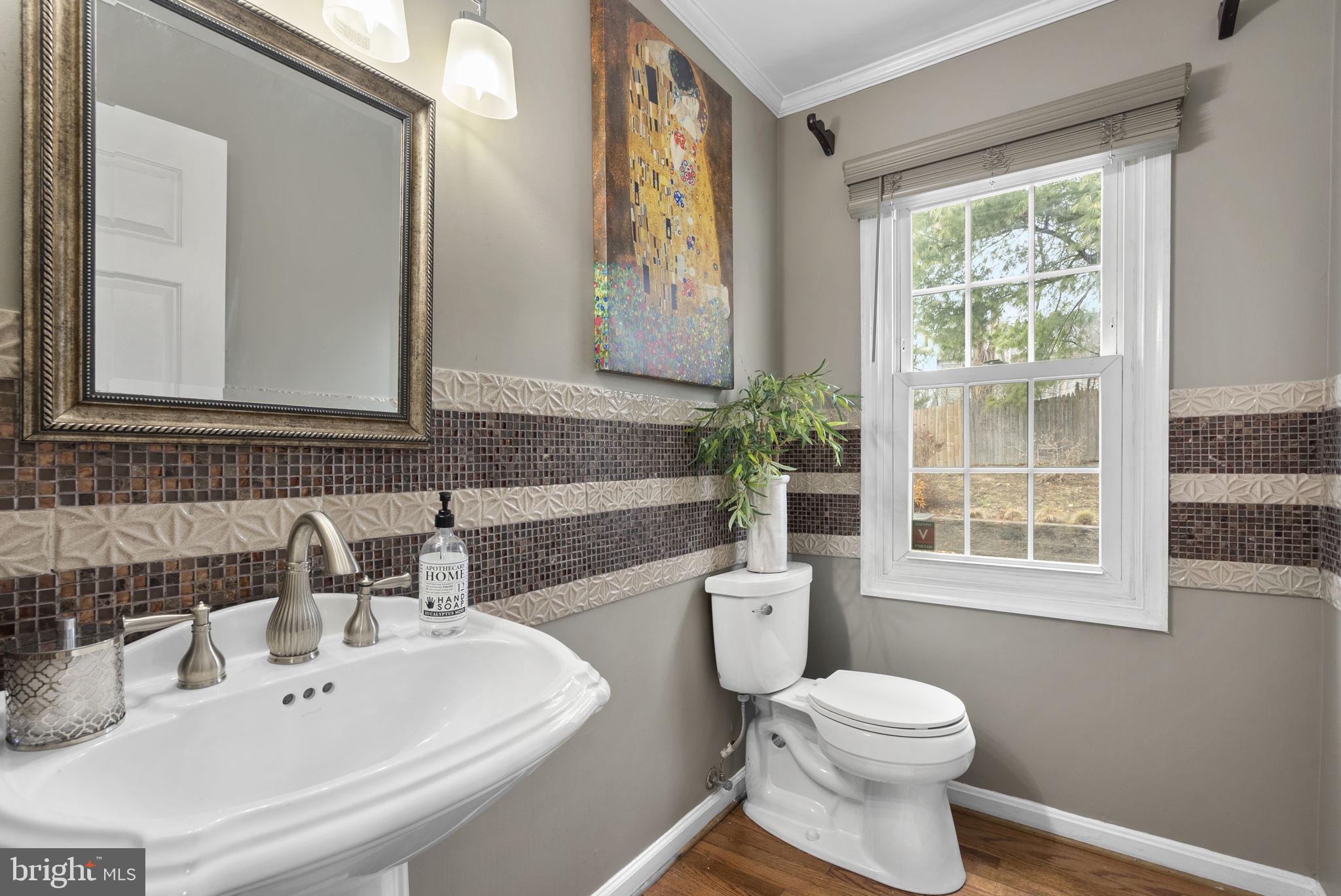 14908 Village Gate Drive Silver Spring, MD 20906 - Photo 18 of 57 a bathroom with a toilet a sink and a large mirror