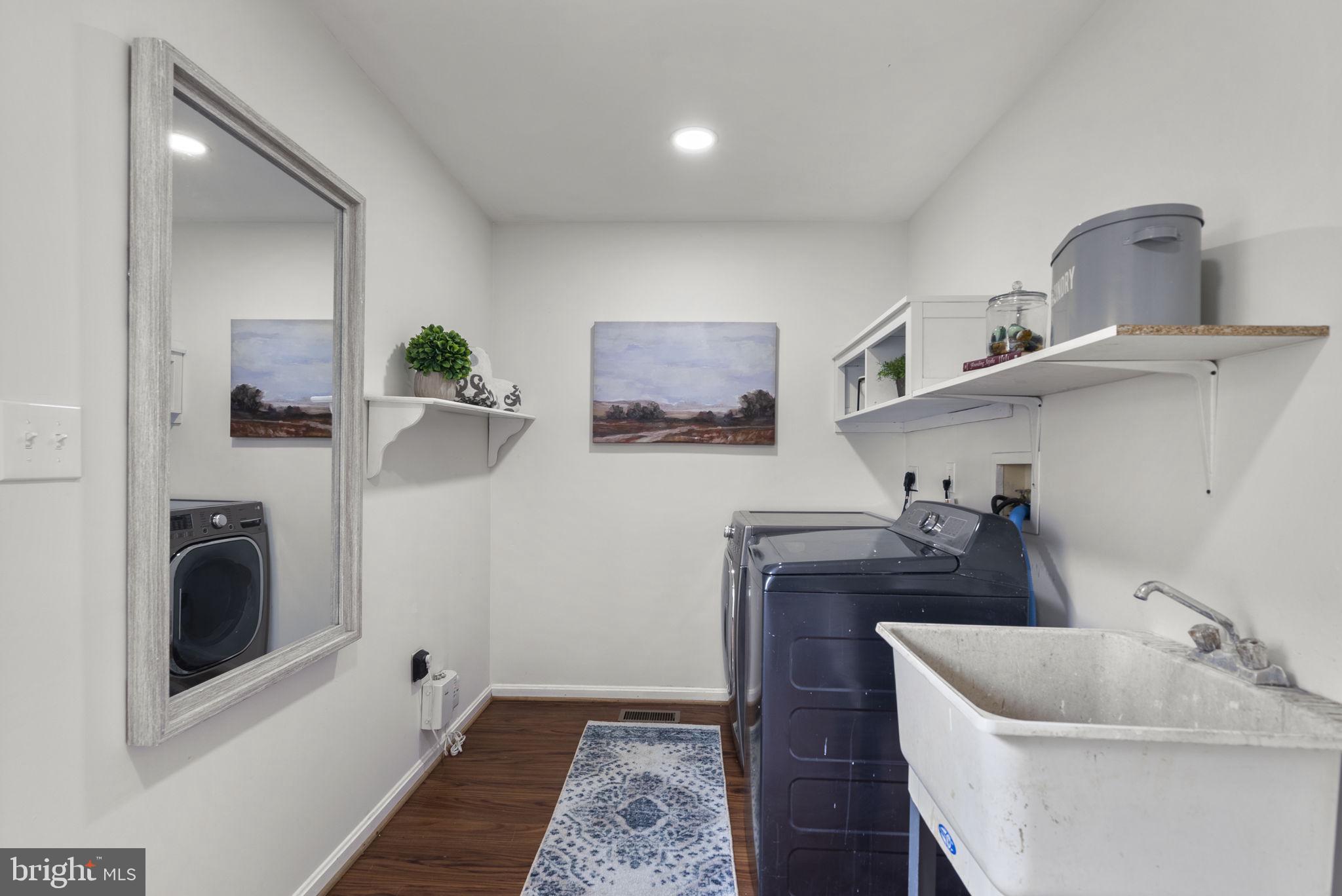14908 Village Gate Drive Silver Spring, MD 20906 - Photo 19 of 57 a bathroom with a sink and a washer dryer