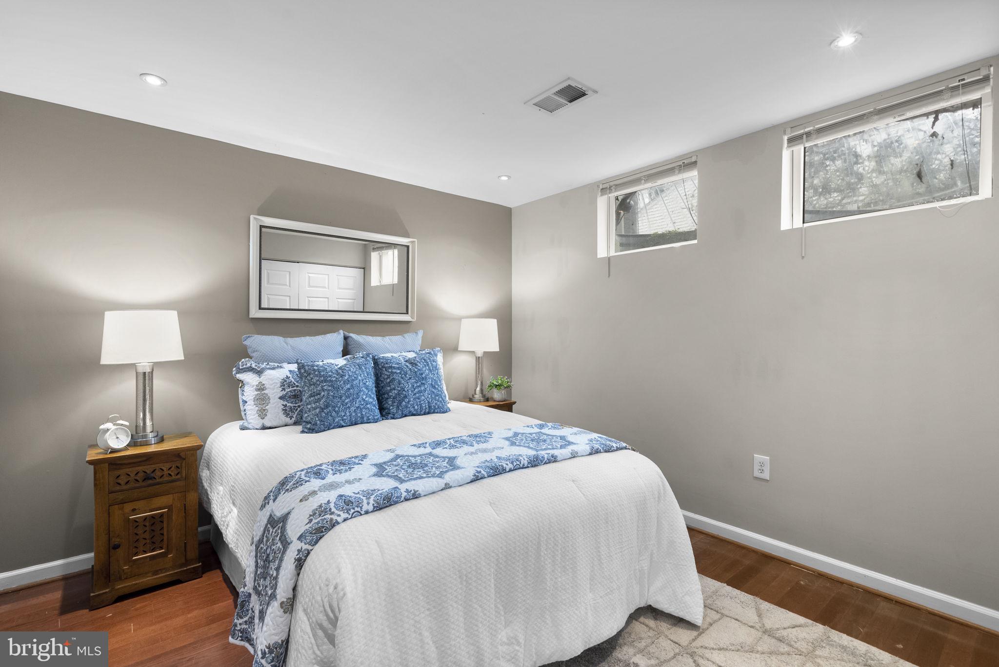 14908 Village Gate Drive Silver Spring, MD 20906 - Photo 37 of 57 a bedroom with a bed and a lamp