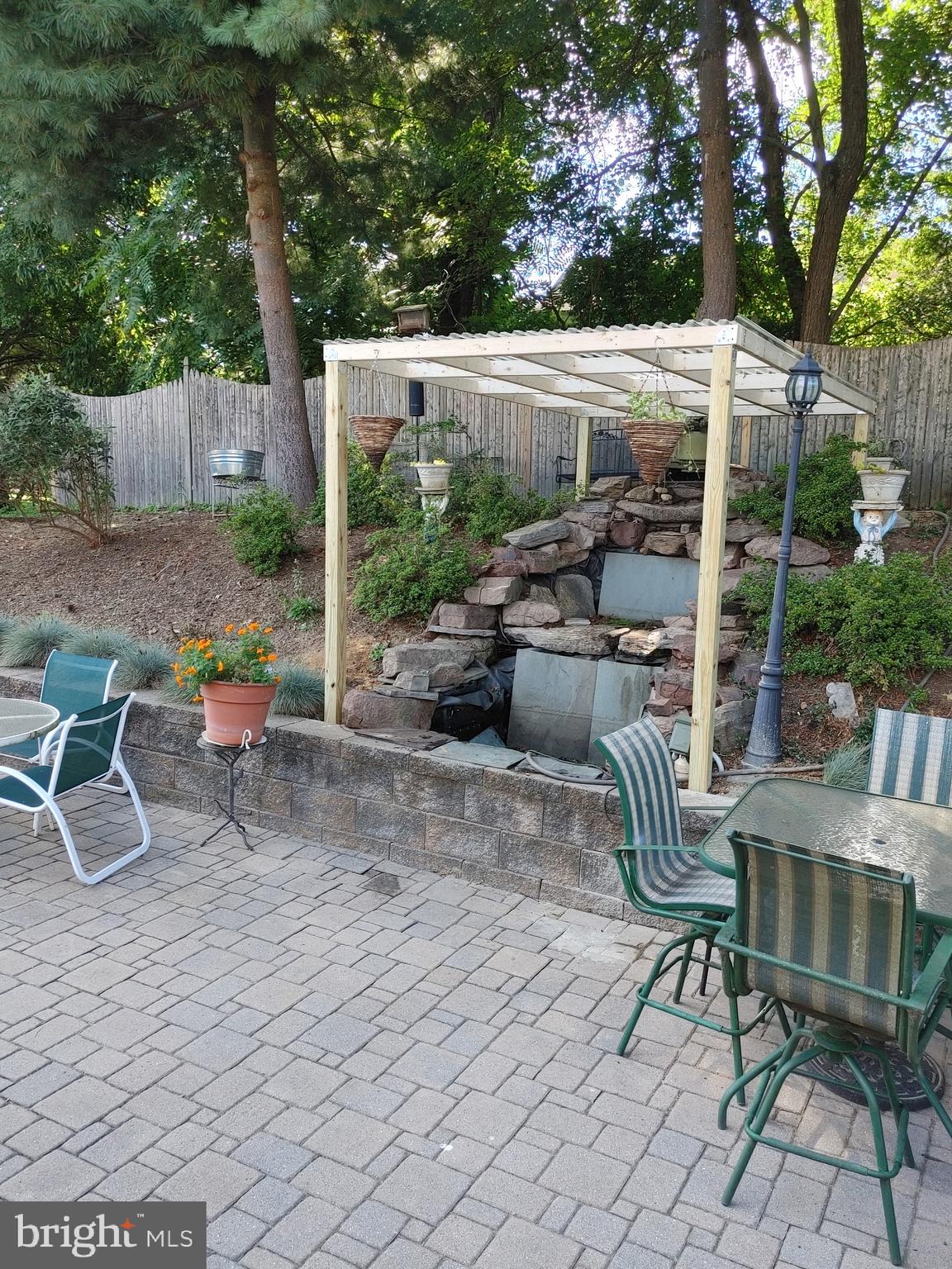 14908 Village Gate Drive Silver Spring, MD 20906 - Photo 42 of 57 a backyard of a house with barbeque oven table and chairs