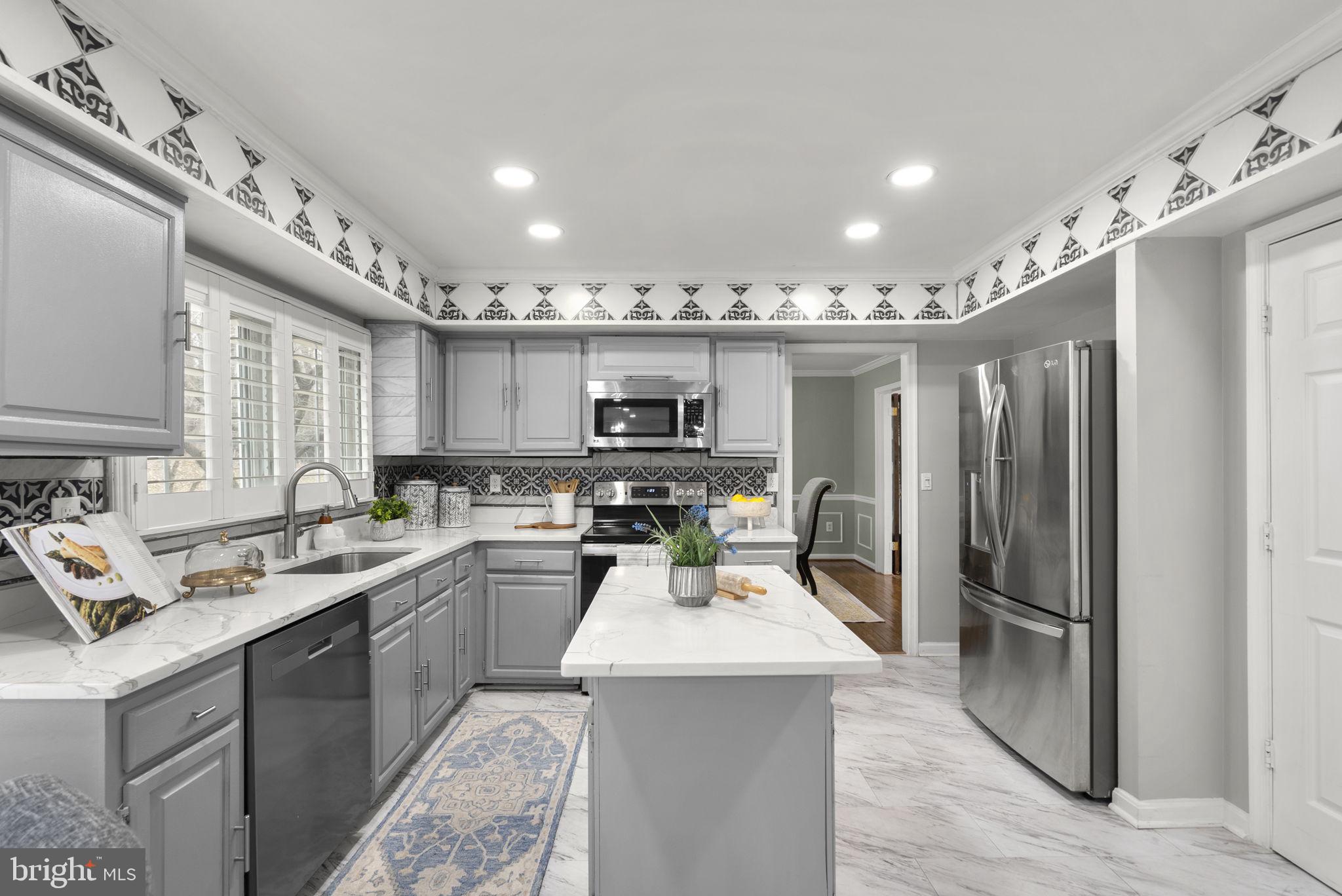 14908 Village Gate Drive Silver Spring, MD 20906 - Photo 7 of 57 a kitchen with stainless steel appliances granite countertop a sink stove and refrigerator