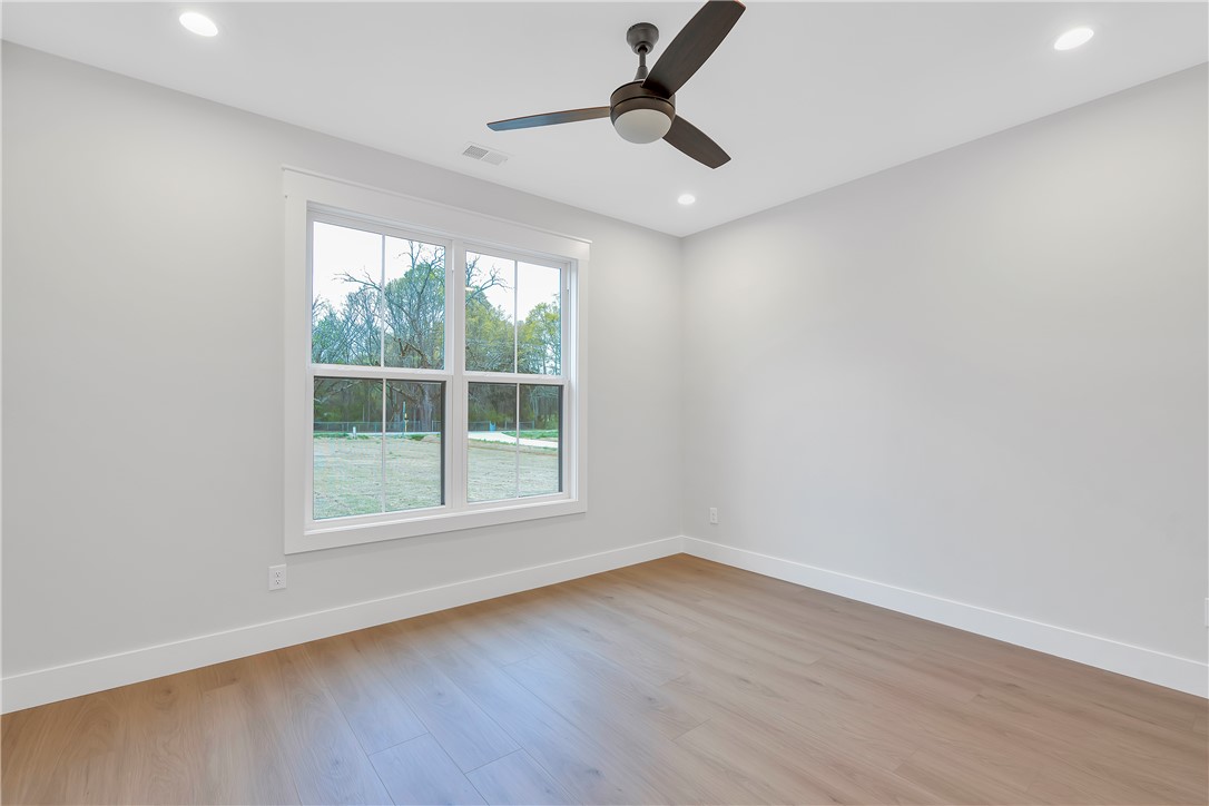 4554 Flat Rock Road Iva, SC 29655 - Photo 18 of 32 A quiet, adaptable space with recessed lighting and a ceiling fan, offering views of the expansive yard.