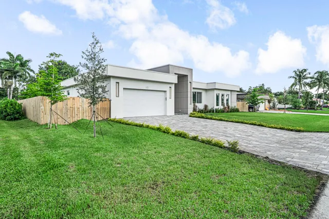 a view of a house with a yard and a garden