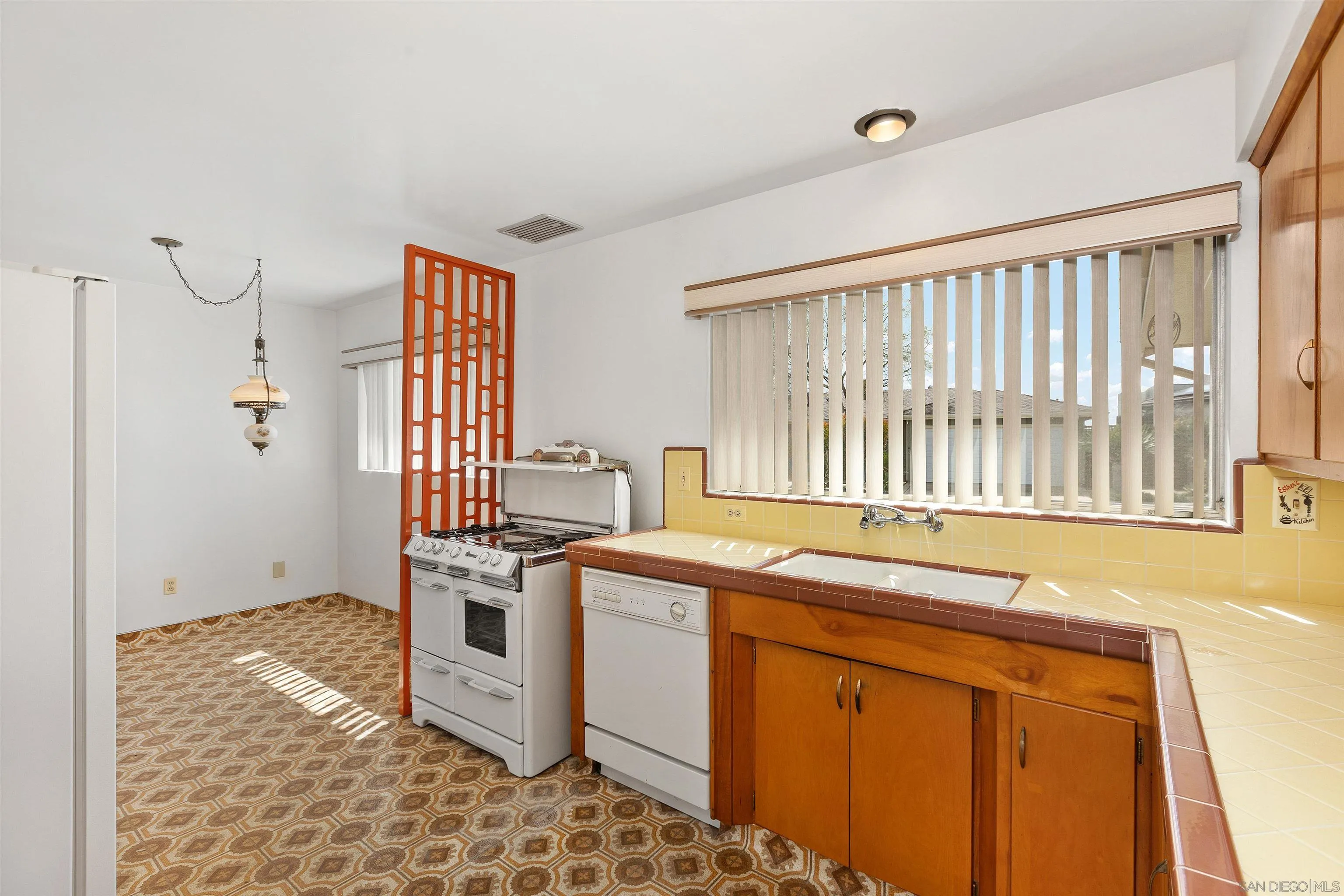 4552 Lucille Drive San Diego, CA 92115 - Photo 11 of 35 a kitchen that has a sink and a stove