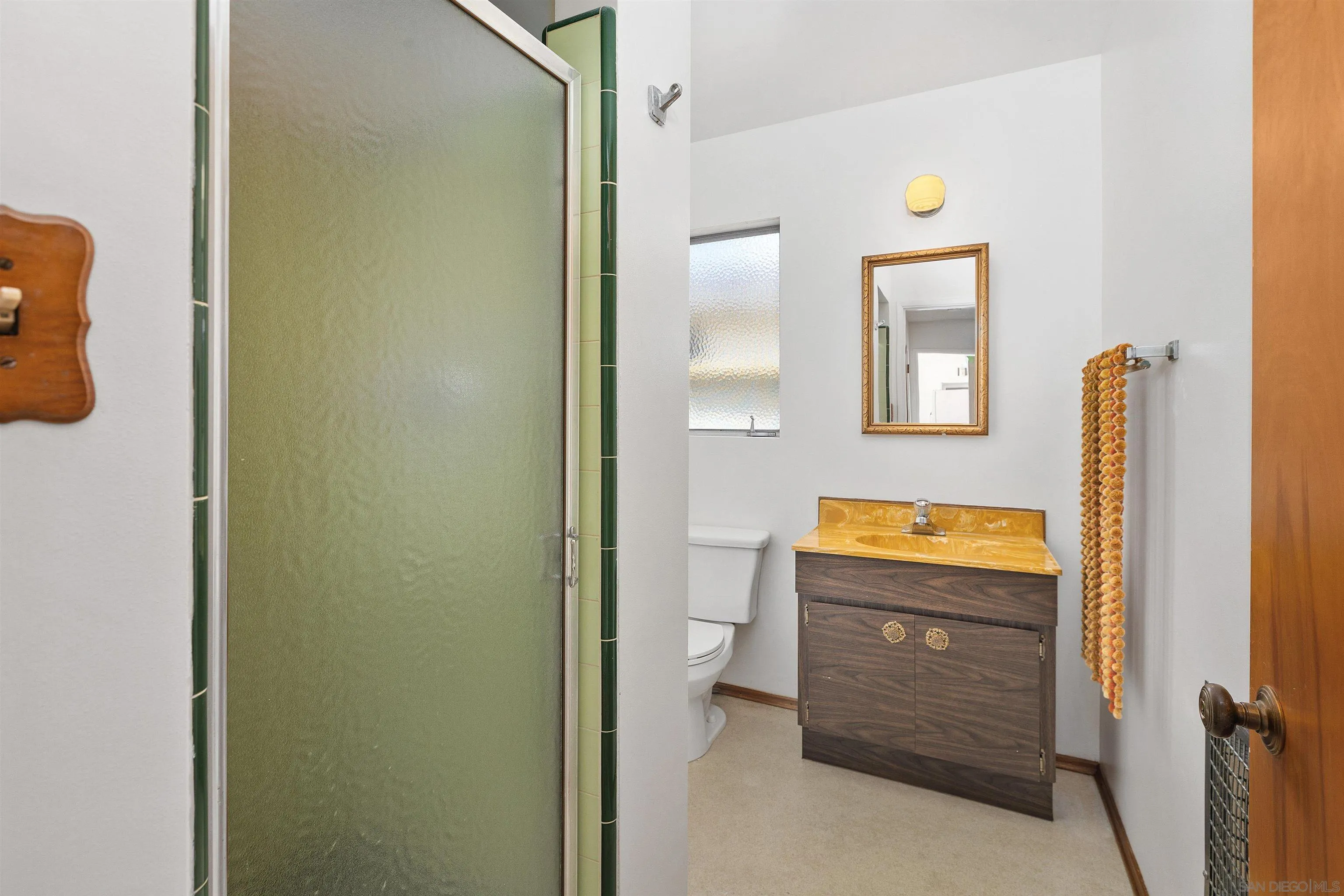 4552 Lucille Drive San Diego, CA 92115 - Photo 20 of 35 a bathroom with a sink and mirror