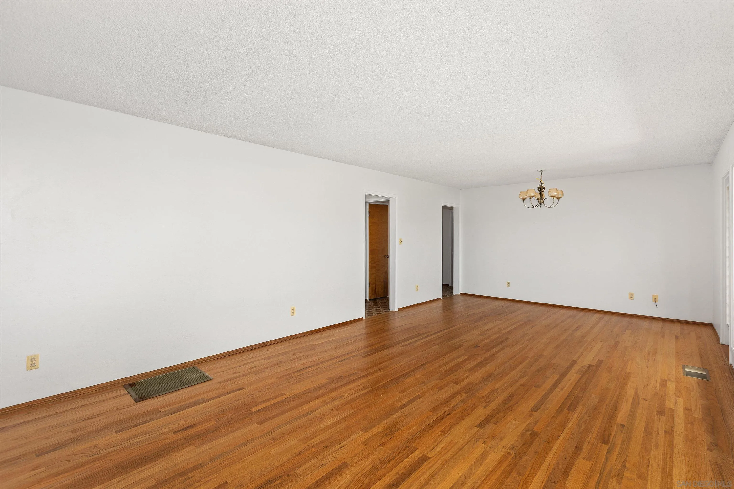 4552 Lucille Drive San Diego, CA 92115 - Photo 7 of 35 a view of an empty room with wooden floor