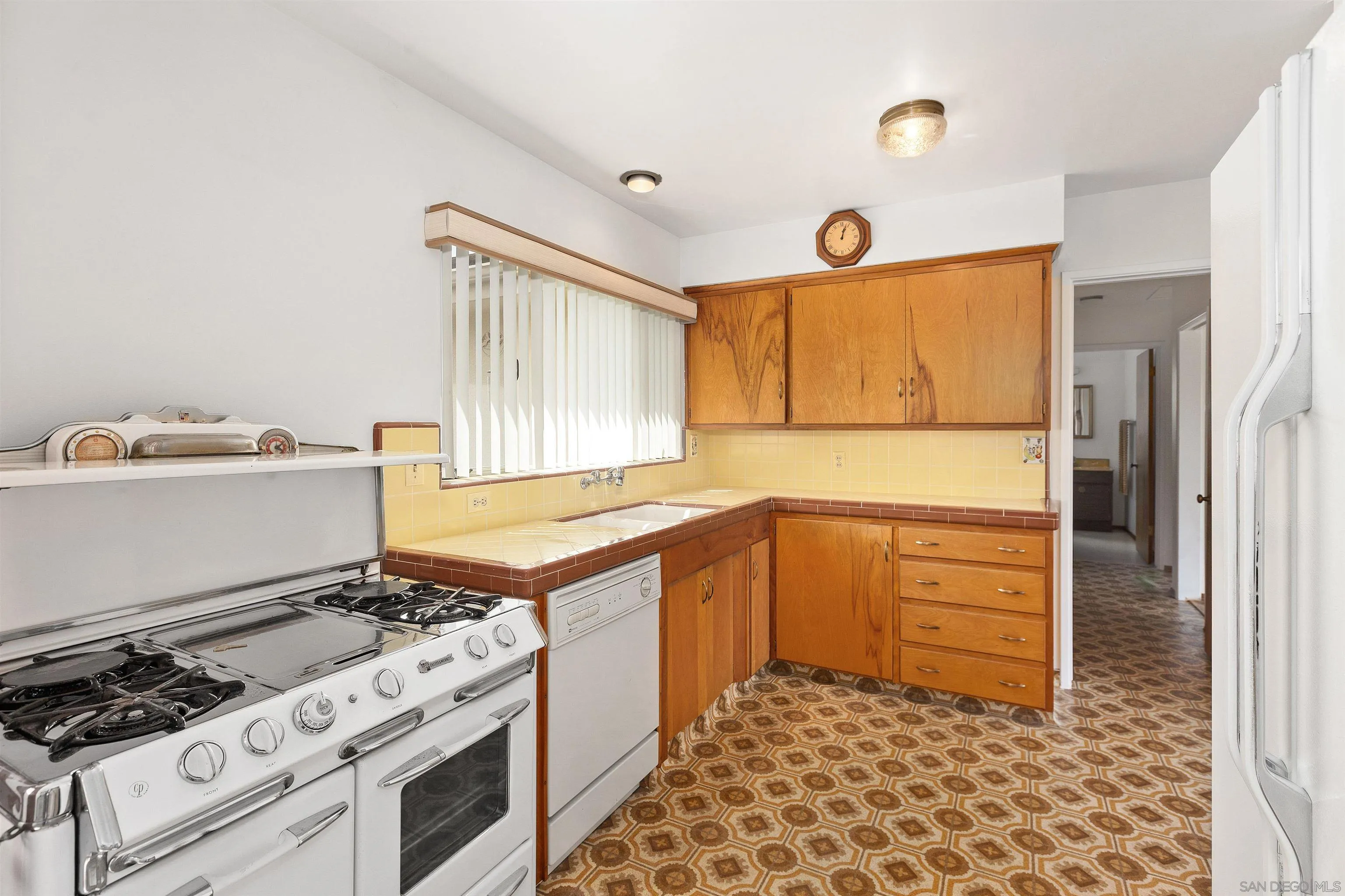 4552 Lucille Drive San Diego, CA 92115 - Photo 9 of 35 a kitchen with granite countertop a stove and a refrigerator