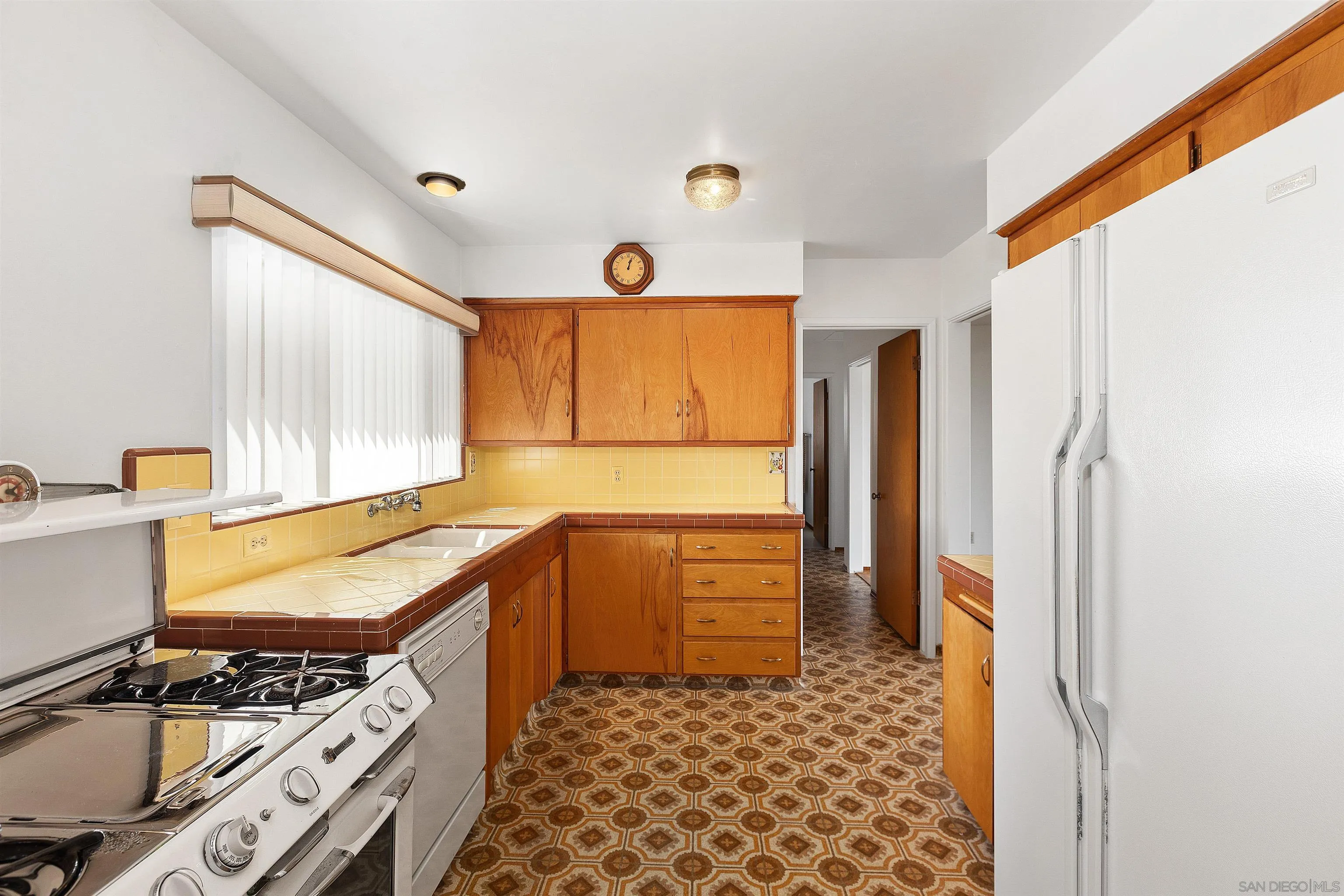 4552 Lucille Drive San Diego, CA 92115 - Photo 10 of 35 a kitchen with a refrigerator and a stove