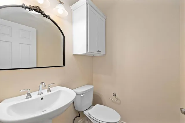 a bathroom with a granite countertop sink a toilet and a bathtub