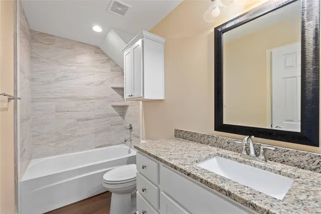 a view of a house with a yard and wooden fence