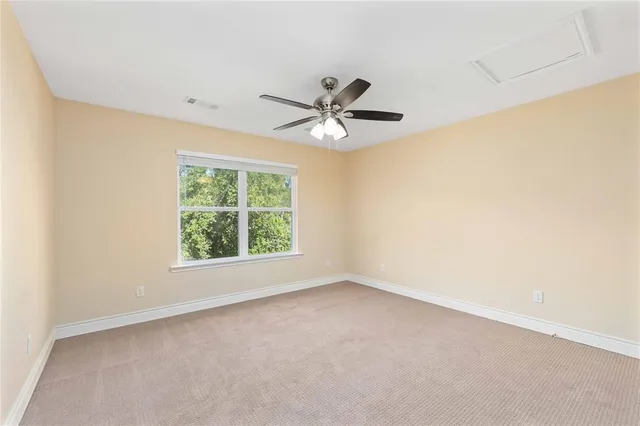 a view of a yard with wooden fence