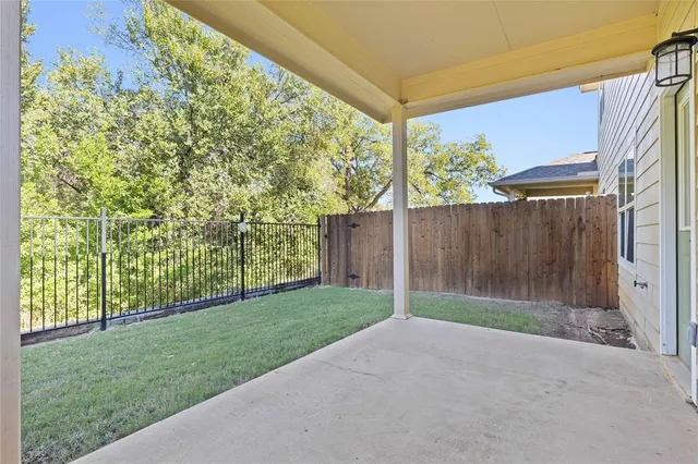 a living room with furniture and potted plants