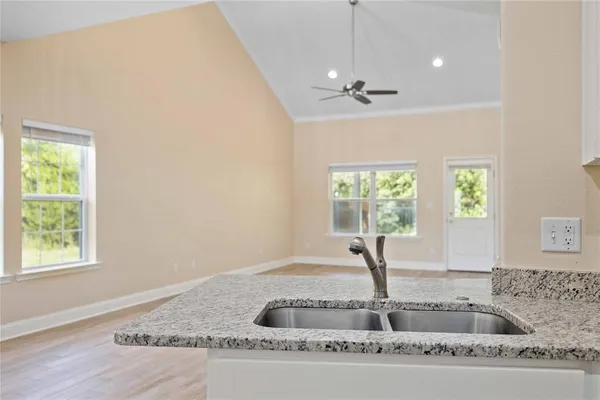 a view of a livingroom with a ceiling fan and window