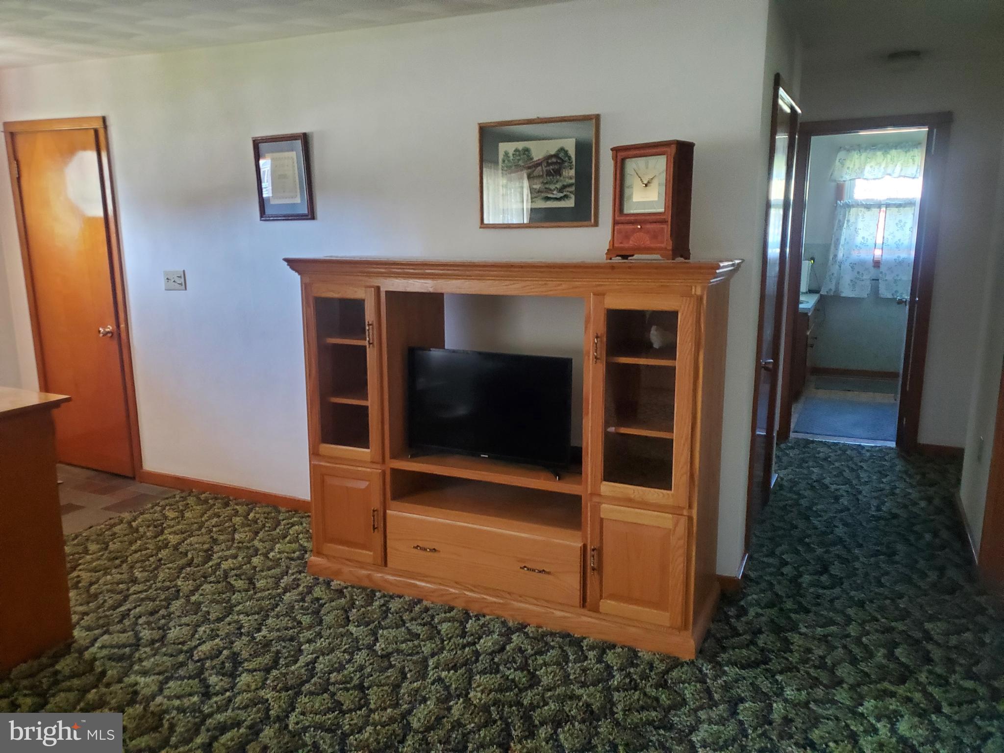 161 Pike Road Howard, PA 16841 - Photo 6 of 15 a living room with a fireplace and a table