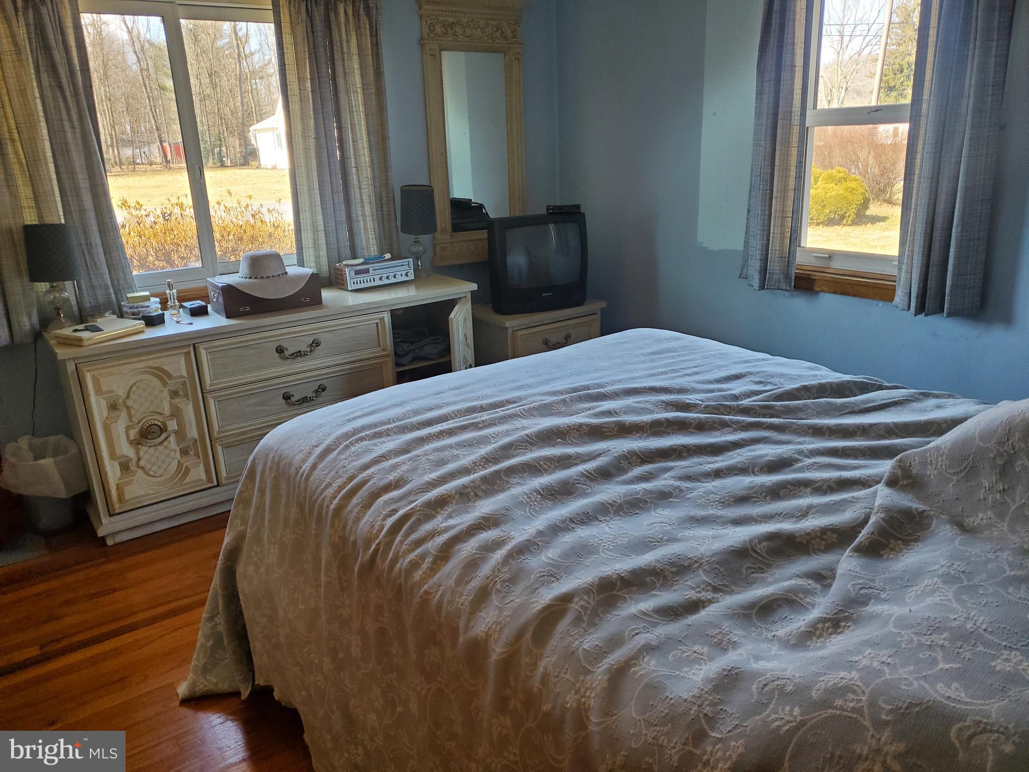 161 Pike Road Howard, PA 16841 - Photo 9 of 15 a bedroom with a bed a large window with wooden floor