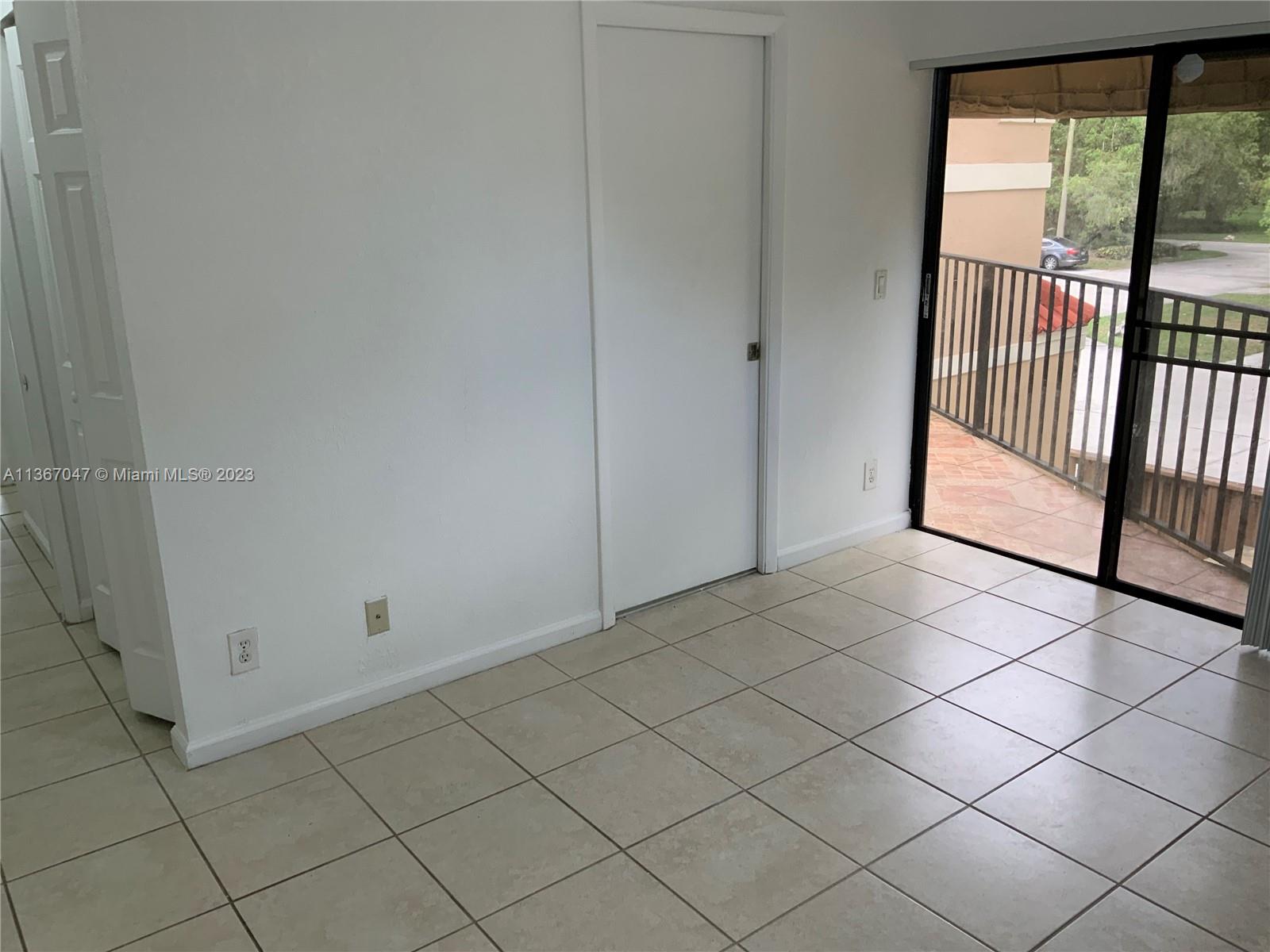 8110 Severn Drive, Unit C Boca Raton, FL 33433 - Photo 17 of 31 an empty room with sliding door and mountain view