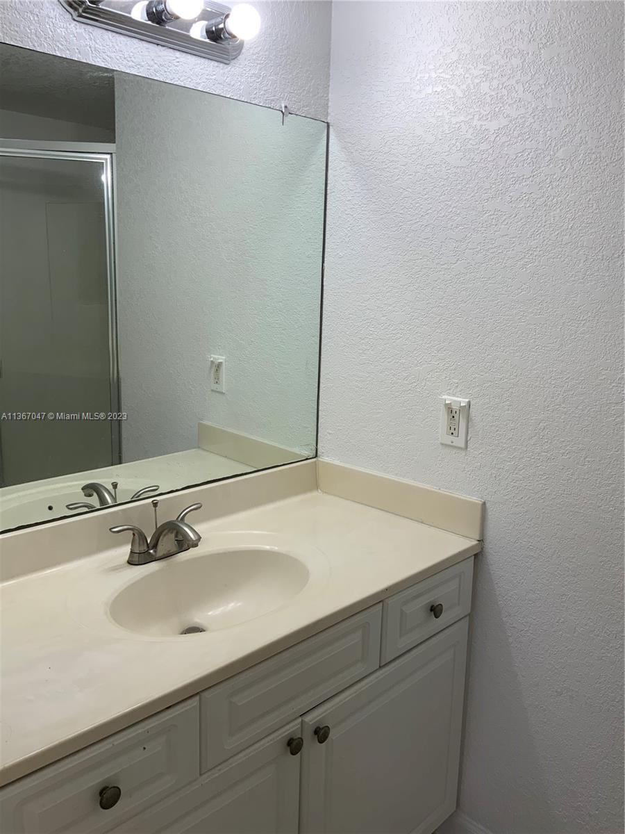 8110 Severn Drive, Unit C Boca Raton, FL 33433 - Photo 18 of 31 a bathroom with a sink and a mirror