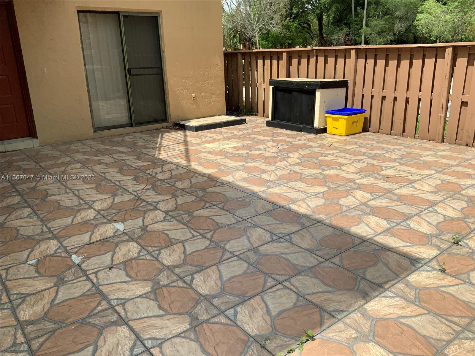 8110 Severn Drive, Unit C Boca Raton, FL 33433 - Photo 19 of 31 a backyard of a house with wooden floor and fence