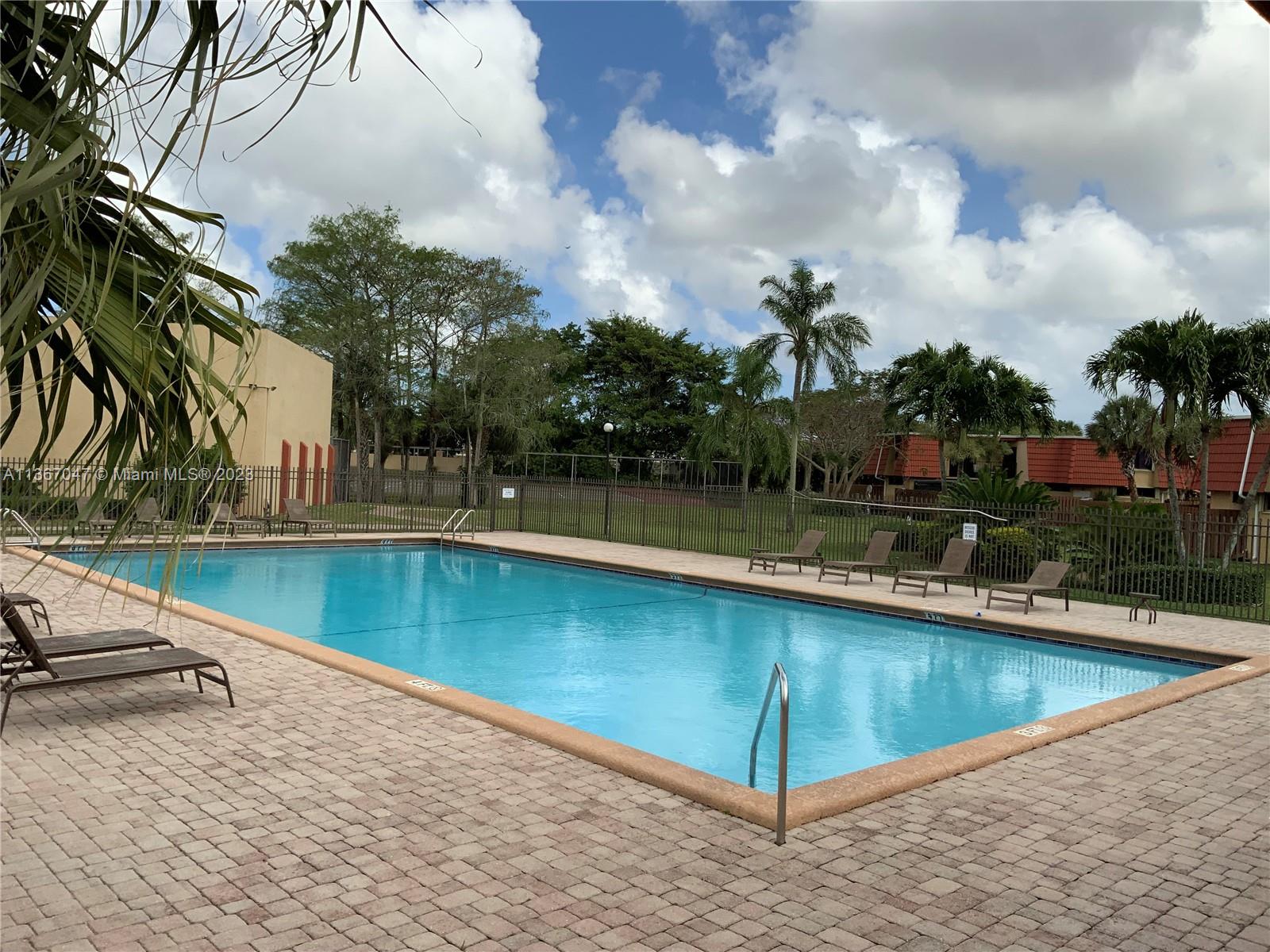 8110 Severn Drive, Unit C Boca Raton, FL 33433 - Photo 22 of 31 a view of a swimming pool with a patio