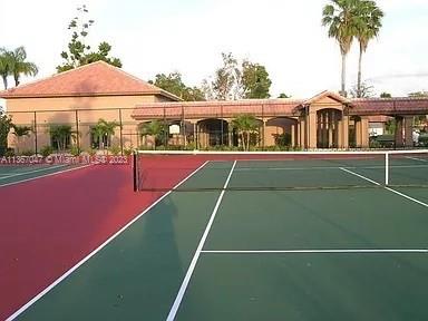 8110 Severn Drive, Unit C Boca Raton, FL 33433 - Photo 24 of 31 a view of a tennis ground with large trees in front of it
