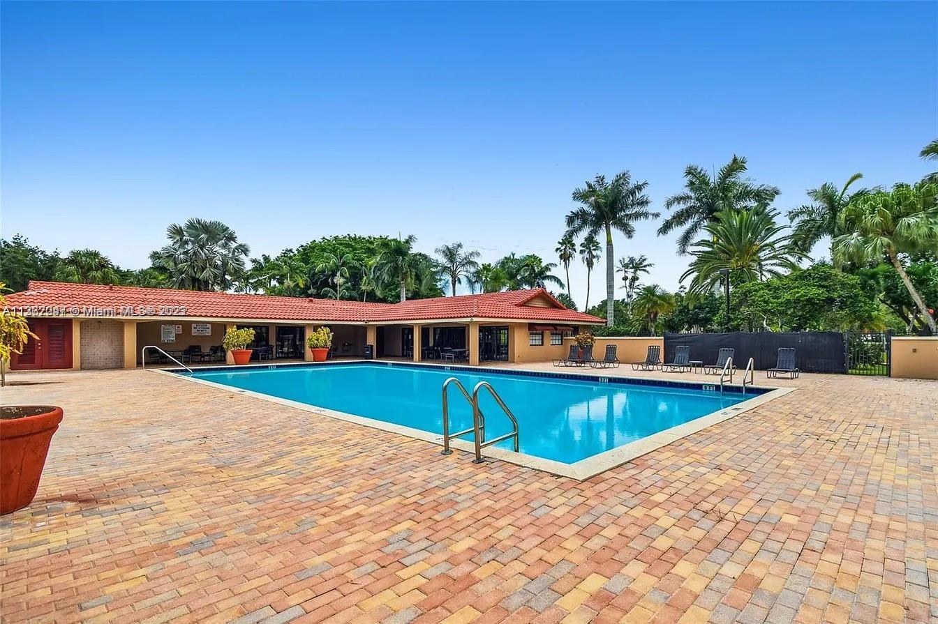 8110 Severn Drive, Unit C Boca Raton, FL 33433 - Photo 30 of 31 a view of a house with pool and yard