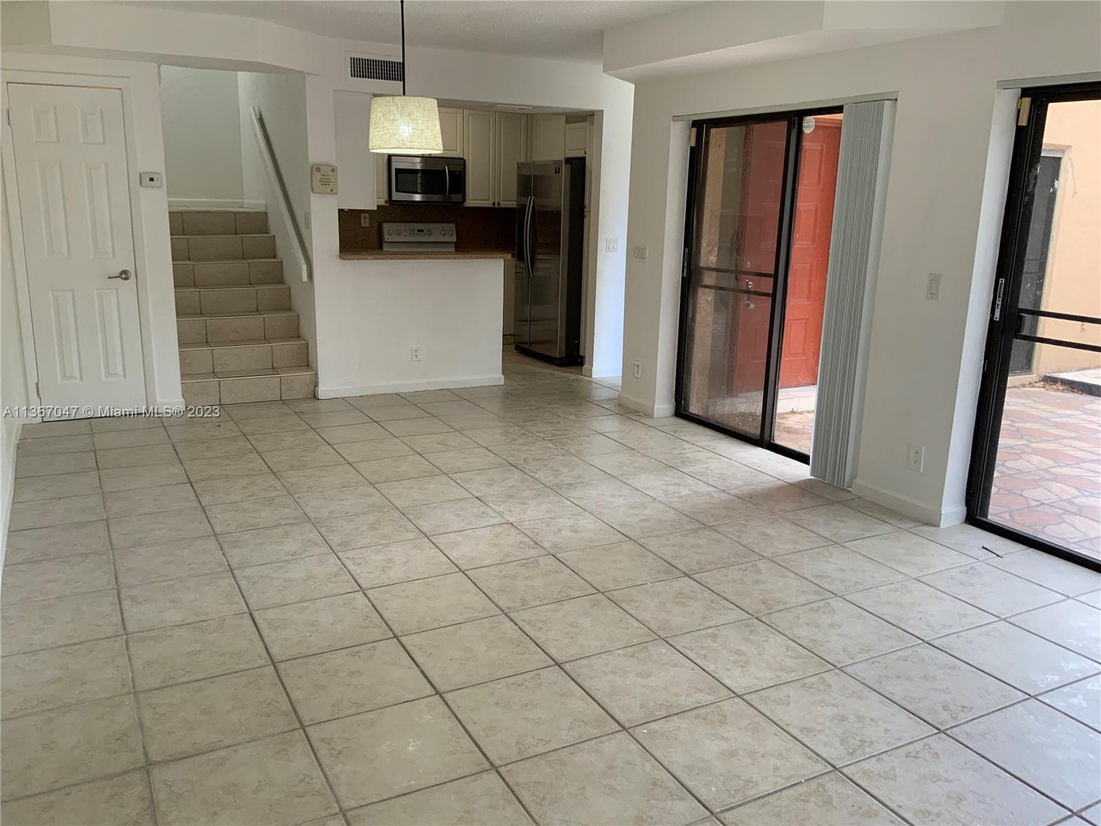 8110 Severn Drive, Unit C Boca Raton, FL 33433 - Photo 9 of 31 a view of a kitchen with fridge and a sink