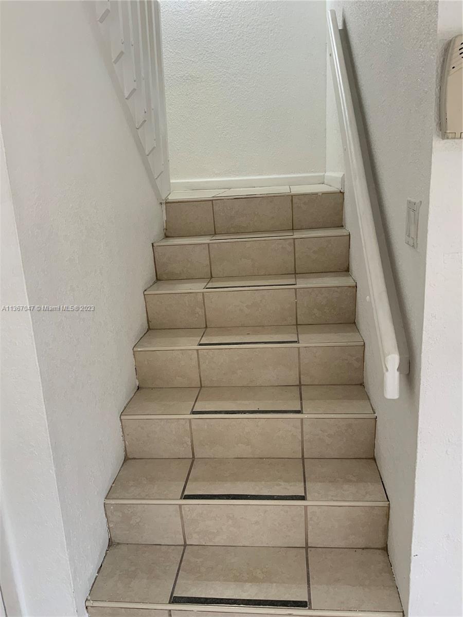 8110 Severn Drive, Unit C Boca Raton, FL 33433 - Photo 10 of 31 a view of staircase with white walls and a window