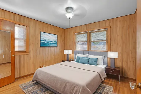 a bedroom with a bed and wooden floor