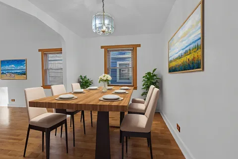 a view of a dining room with furniture wooden floor and a chandelier