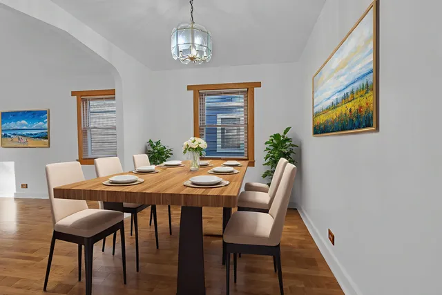 a view of a dining room with furniture wooden floor and a chandelier