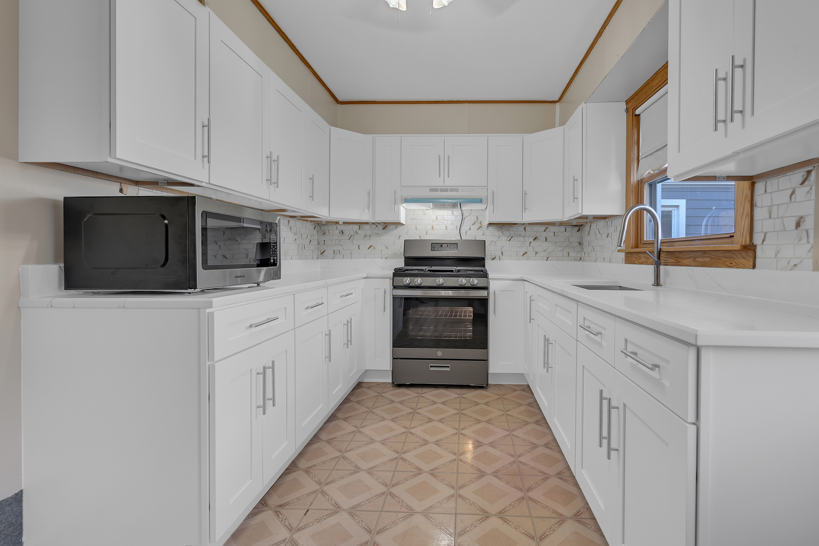 31 46th Avenue Bellwood, IL 60104 - Photo 7 of 30 a kitchen with granite countertop white cabinets and stainless steel appliances