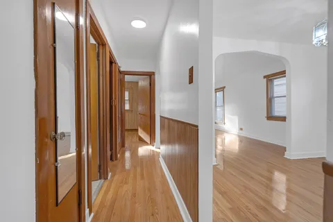 a view of a hallway with wooden floor