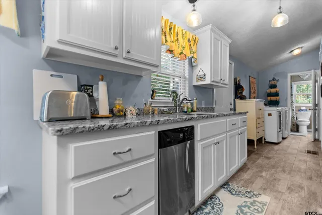 a kitchen with stainless steel appliances granite countertop a sink and cabinets