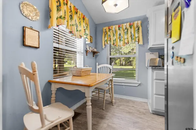 a dining room with furniture and a window
