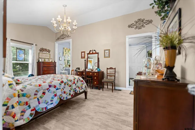 a bedroom that has a bed and a dresser in it