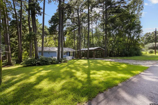 a swimming pool with outdoor seating and yard
