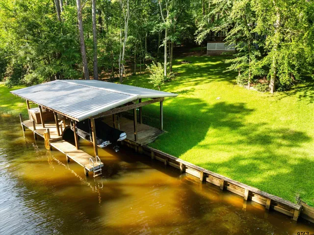 swimming pool view with a garden and trees
