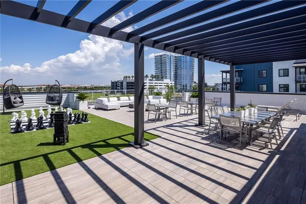 a view of a chair and tables in the patio and a garden