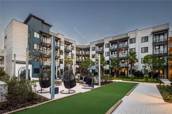 a living room with furniture and wall painting