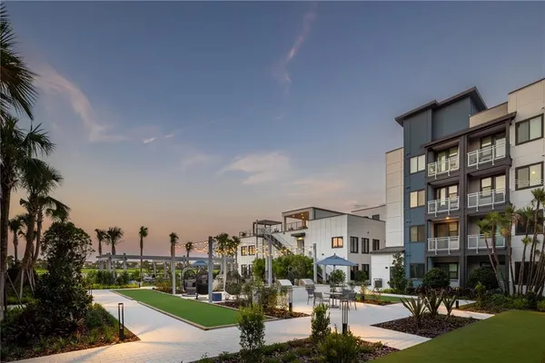 a living room with furniture and a floor to ceiling window