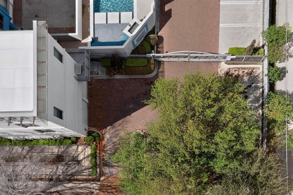 4414 Cedar Springs Road, Unit 318 Dallas, TX 75219 - Photo 14 of 40 Modern exterior featuring a private courtyard, brick paver driveway, and a partially covered swimming pool