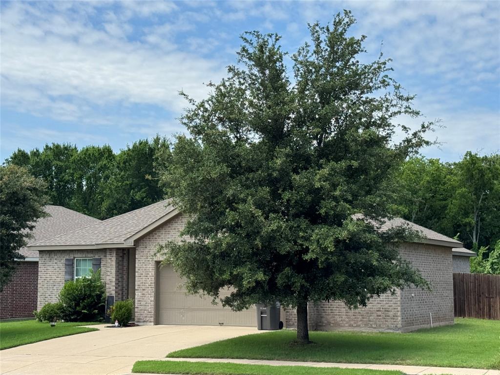 2209 Cinnamon Spgs Road Glenn Heights, TX 75154 - Photo 11 of 28 Brick exterior residence featuring a two-car garage with a complementary garage door