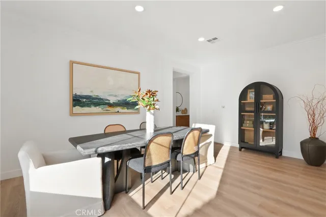 a view of a dining room with furniture and a wooden floor