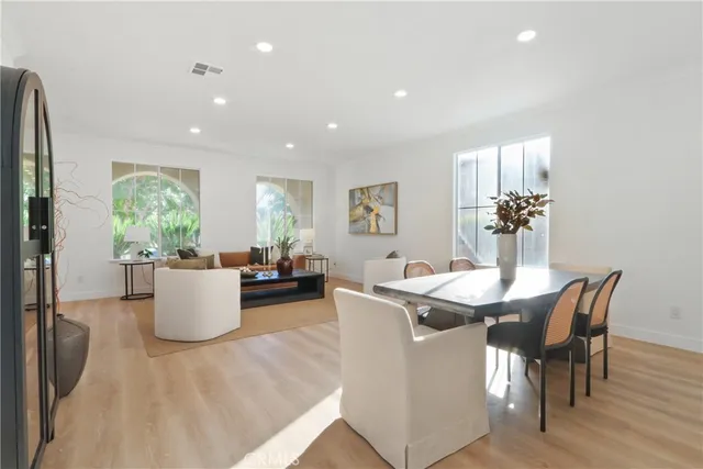 a dining room with furniture and wooden floor