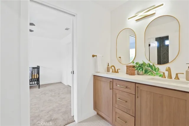 a bathroom with a double vanity sink and a mirror