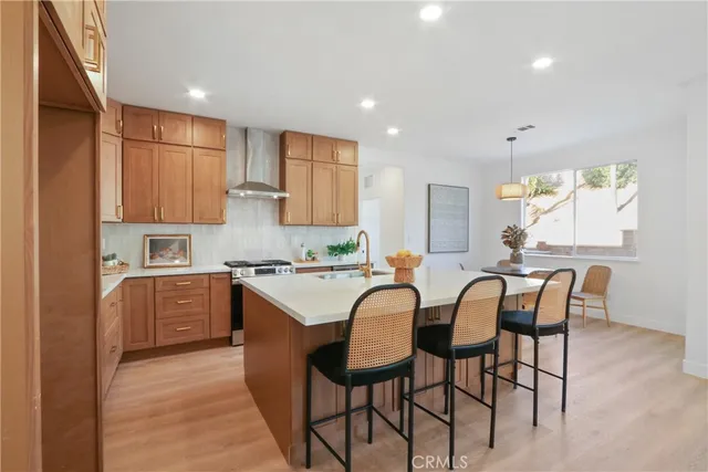 a kitchen with cabinets and chairs