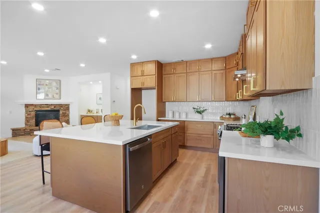 a kitchen with sink a microwave and cabinets