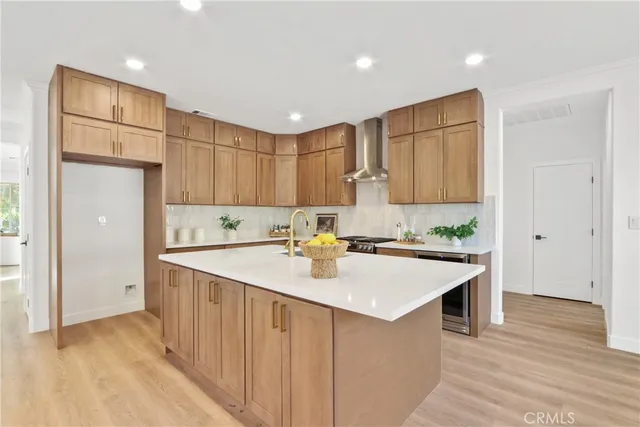 a kitchen with a sink a stove a refrigerator and white cabinets