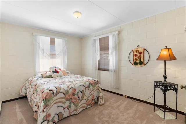 a bedroom with a bed and a lamp